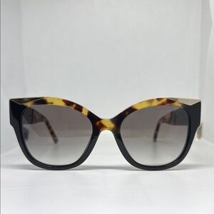Prada sunglasses with tortoise shell partial frame.